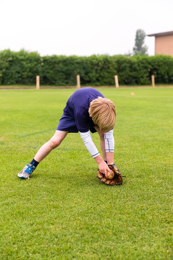 Little league baseball player infielding drill.